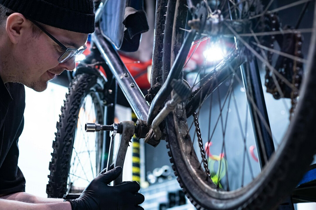 man repairing bicycle