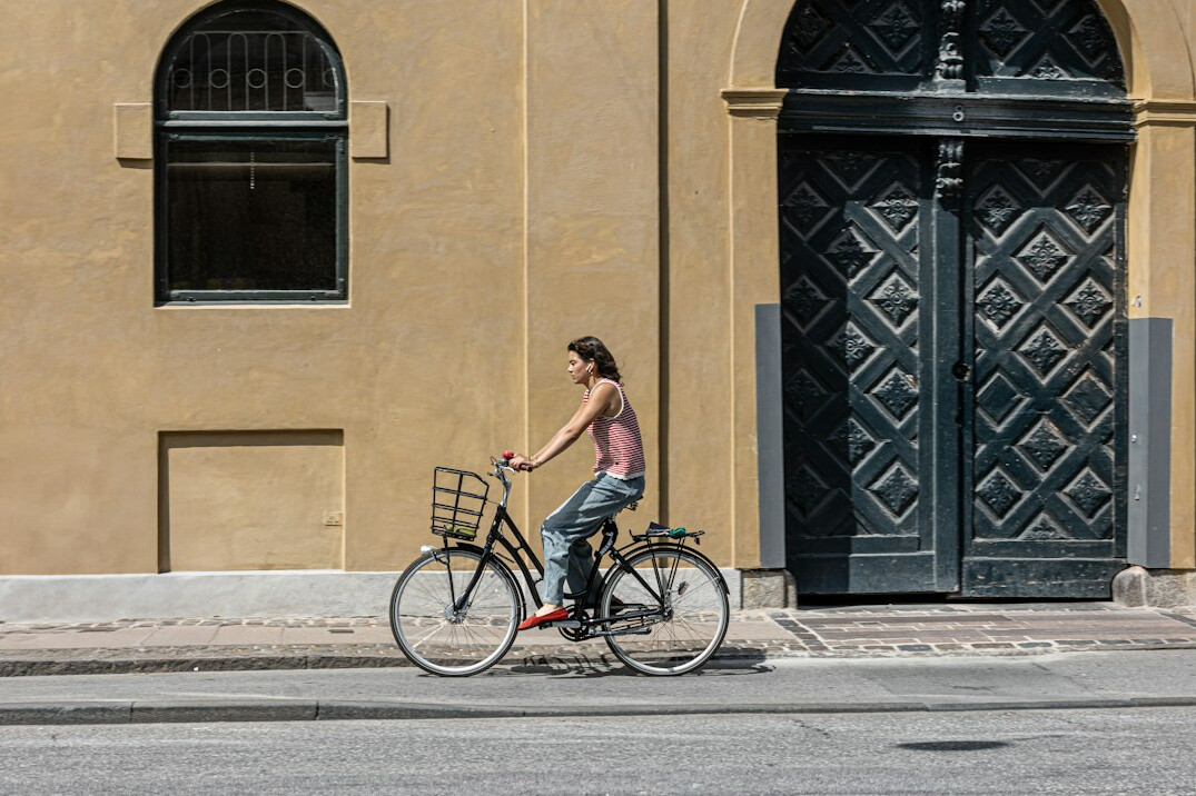 Woman carrying groceries on a bicycle in Denmark