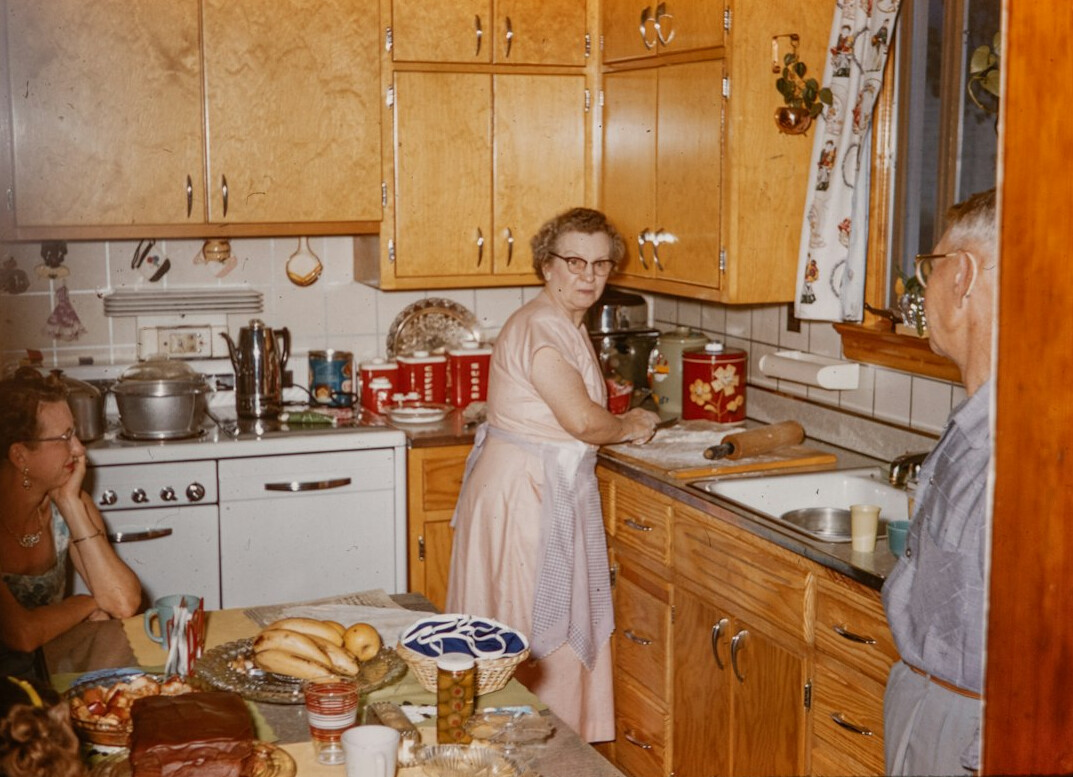 Danish family gathered in a kitchen making breakfast